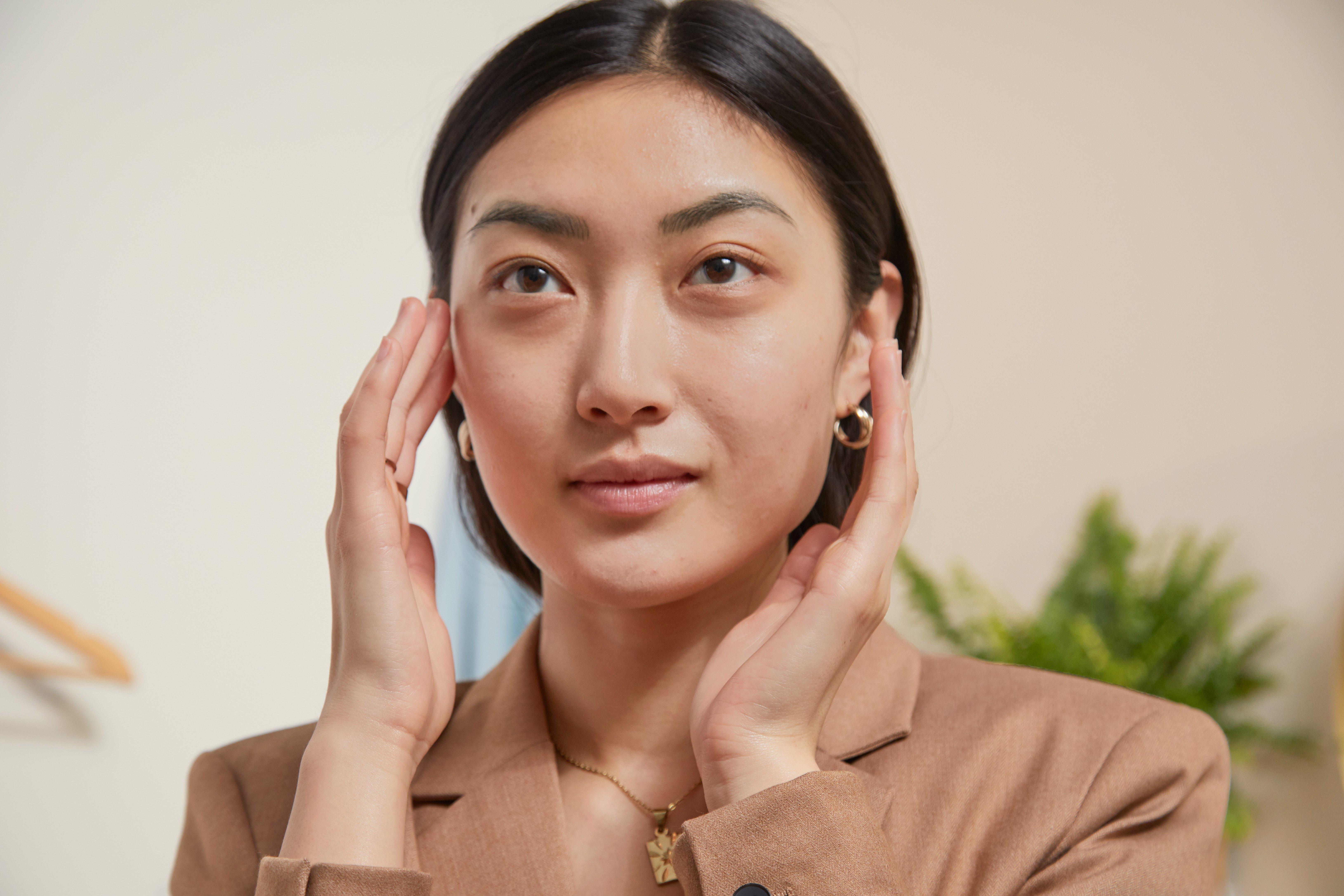 woman touching her face